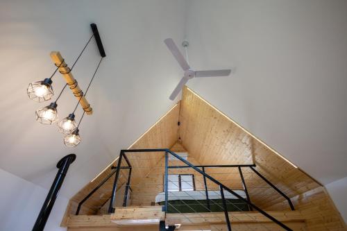 a spiral staircase with a glass railing and a ceiling at MILLAR's in Sovata