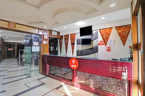 a lobby with a bar in a building at OYO Flagship Hotel park view 1 in Meerut