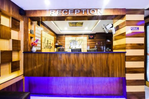 a bar in a restaurant with a sign that reads reception at Meera International in Āsansol