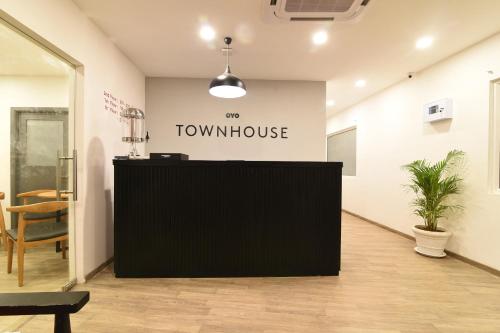 a view of a front desk in a room with a table at Super Townhouse Royapettah Near U.S Consulate in Chennai