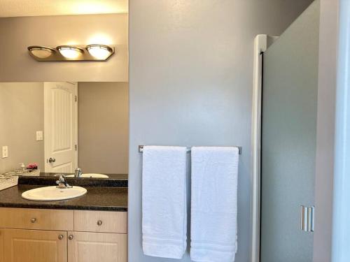 a bathroom with a refrigerator and a sink with towels at Comfortable 6 bedrooms house in Hinton