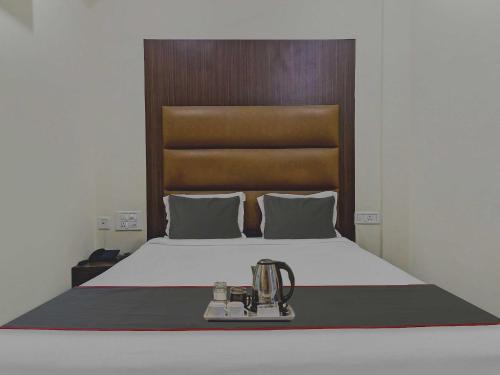 a bedroom with a bed with aigil at Collection O THE CROWN HOTEL in Hyderabad