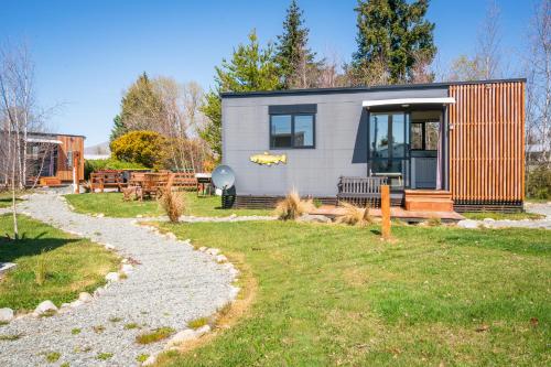 a tiny house in a yard with a pathway at Stunted Totara, Unit 4 in Twizel