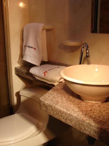 a bathroom with a sink and a toilet at Hotel Castellana Inn in Bogotá