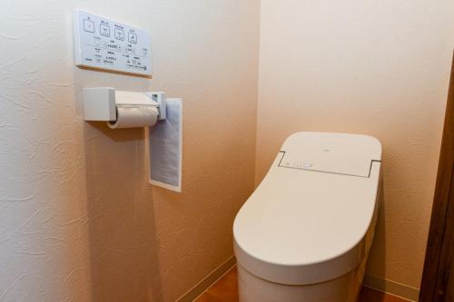 a bathroom with a toilet in a room at El Patio Ranch in Aso