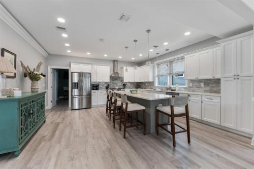 a kitchen with white cabinets and a table and chairs at 7208 Atlantic Ave in Wildwood Crest