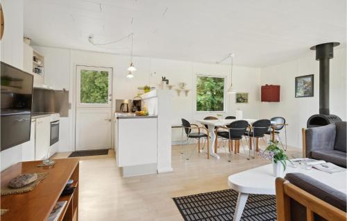 a kitchen and living room with a table and chairs at 3 Bedroom Amazing Home In Børkop in Børkop