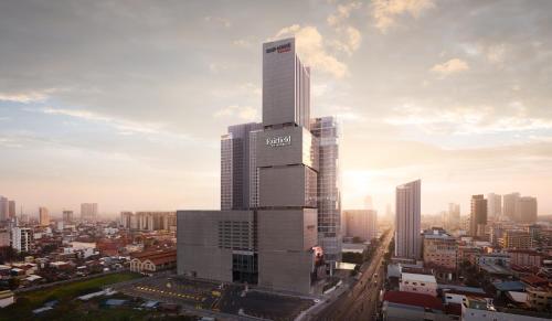 a tall building in the middle of a city at Fairfield by Marriott Phnom Penh in Phnom Penh