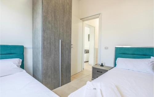 two beds sitting next to each other in a bedroom at 8 Bedroom Gorgeous Home In Cava D'aliga in Cava dʼAliga