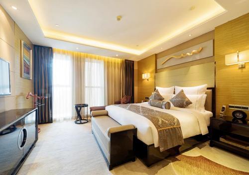 Ένα ή περισσότερα κρεβάτια σε δωμάτιο στο Pullman Wuxi New Lake