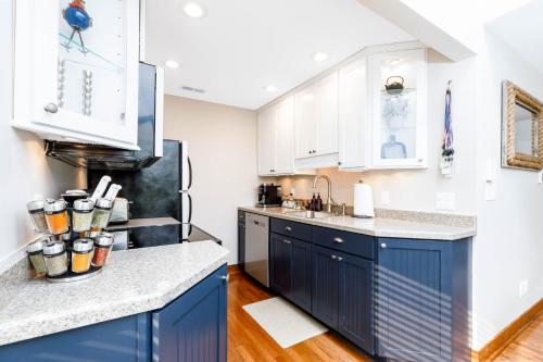 a kitchen with blue cabinets and white appliances at Fall Specials! Cozy King Beds, Pool Access, Galena Territory Amenities, Fireplace, Great Location in Galena Territory on Lake Galena in Galena