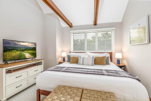 a bedroom with a large bed and a tv at Mother's Day Special! King Beds, Pool Access, Fireplace, Great Location in Galena Territory on Lake Galena in Galena