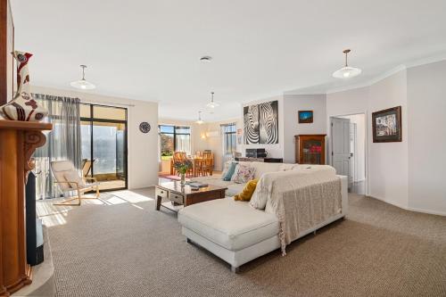a bedroom with a bed and a couch and a living room at Selmes Sanctuary - Blenheim Holiday Home in Blenheim