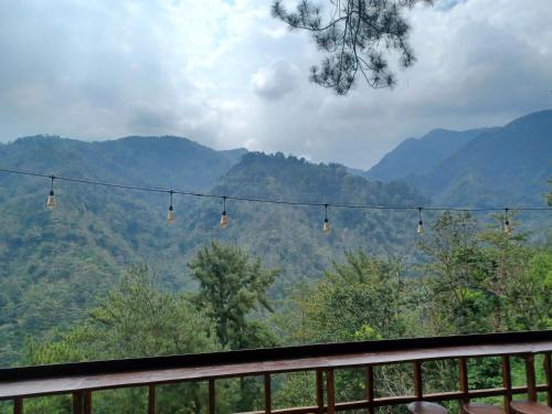 a view of the mountains from a balcony with lights at Villa sunset 