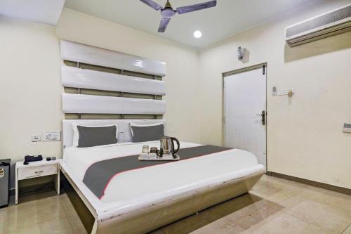 a bedroom with a large white bed and a closet at Collection O THE CROWN HOTEL in Hyderabad