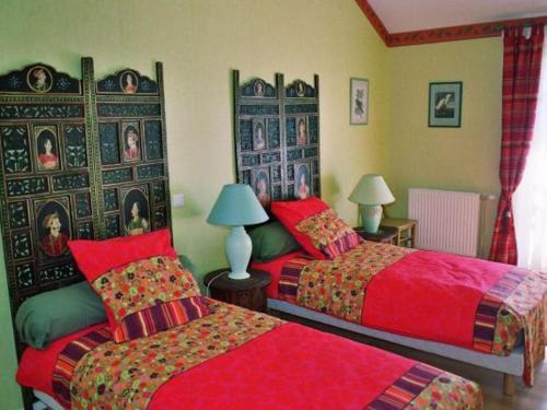 a bedroom with two beds with red sheets at Guestroom Futeau, 1 pièce, 2 personnes - FR-1-585-116 in Futeau