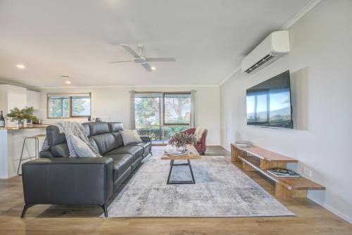 a living room with a couch and a table at Yering Park Cottage in Coldstream