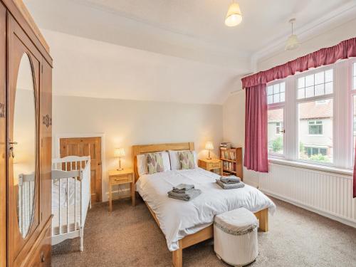 a bedroom with a bed and a window at 15 Elms Road in Bare