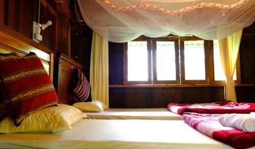 a bedroom with two beds and a window at Plei Homestay & Café in Pleiku