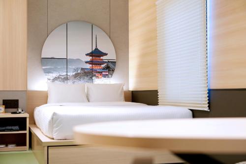 a bedroom with two beds and a window at Travelodge Kyoto Shijo Kawaramachi in Kyoto