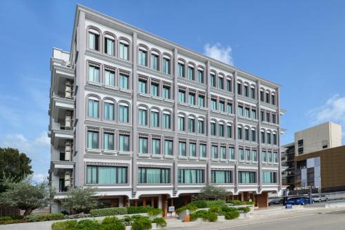 a large white building with many windows at VST Punnawithi in Bangkok