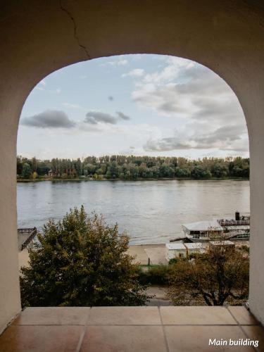 a view of a river from an arch way at Hotel Spichrz in Toruń
