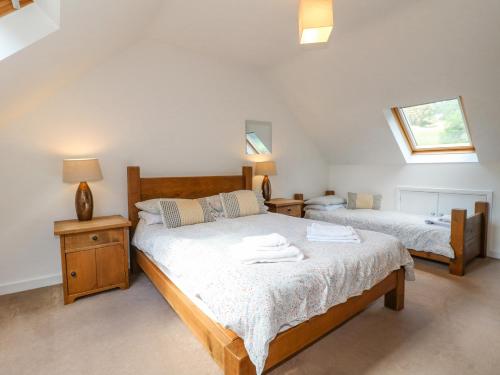 a bedroom with two beds and two night stands at Torestyn in Matlock
