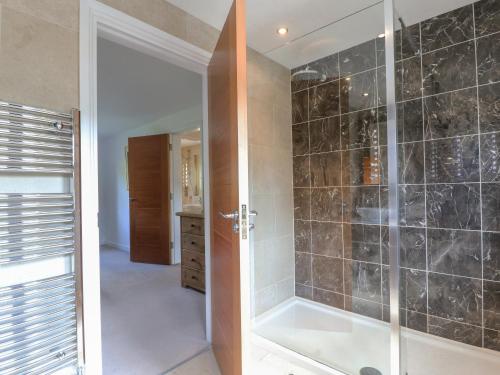 a bathroom with a walk in shower next to a walk in shower at Torestyn in Matlock