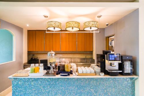 a kitchen with a counter with food on it at La Petite Salil Sukhumvit Thonglor 1 in Bangkok