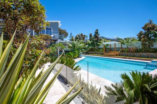 a swimming pool in a house with plants at Blue Lagoon Jervis Bay in Vincentia