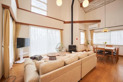 a living room with a large couch and a table at S-villa Nasu Blanca in Nasu