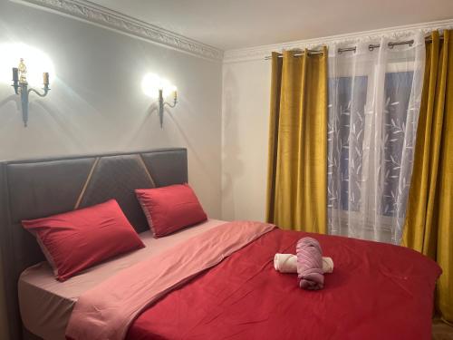 a bed with a stuffed animal sitting on top of it at Apartman Scepanovic in Nikšić