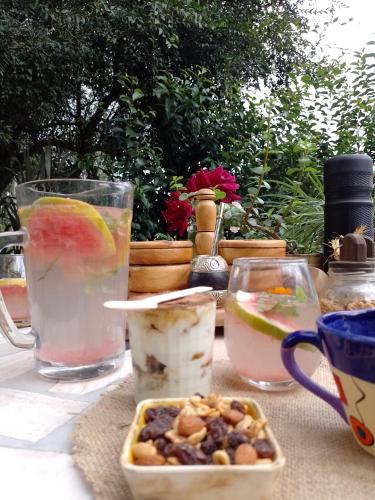 a table with glasses of water and a bowl of food at Casa Villa Alba Carpinteria in Carpintería