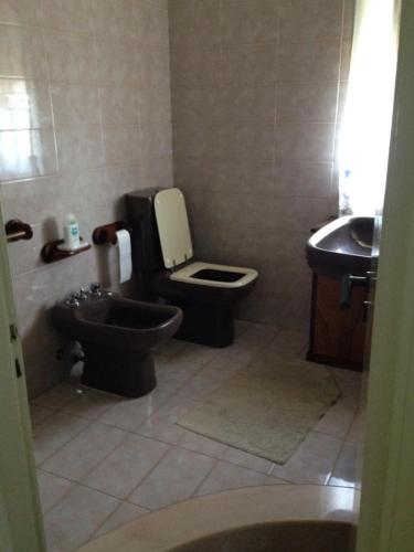 ein Bad mit einem WC und einem Waschbecken in der Unterkunft Sun bay apartment in Agnone Bagni