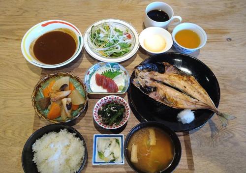 a table with plates of food and bowls of food at APA Hotel Koriyama Ekimae in Koriyama