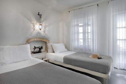 Кровать или кровати в номере 1890s Romanati Boutique House Authentic Village Retreat in Pefki, Makry Gialos