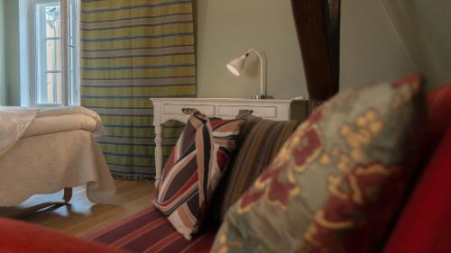 a living room with a couch and a lamp at Karja Accommodation in Haapsalu