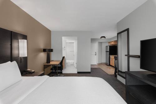a hotel room with a bed and a desk at Residence Inn by Marriott Salt Lake City Downtown in Salt Lake City