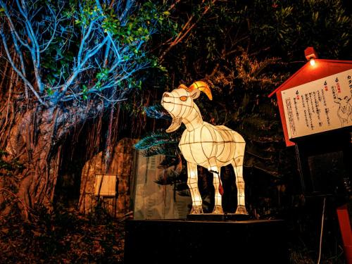 a statue of a sheep is on a display at Hotel Murasakimura in Yomitan