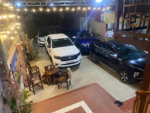 two cars parked in a garage with a table and chairs at Bac Son Homestay in Bắc Sơn