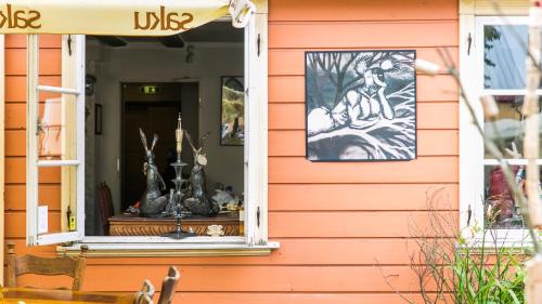 a house with a window with a picture of a dog at Karja Accommodation in Haapsalu