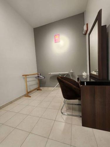 a waiting room with a chair and a mirror at 4R4B SDK Traveler Modern loft overlooking downtown in Sandakan