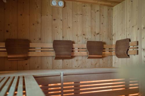 a conference room with three chairs and a clock on the wall at Hotel Oberwirt in Verano