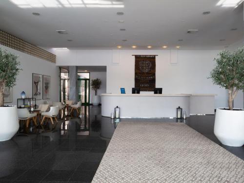 a lobby with a table and chairs and a counter at Bluesun Holiday Village Bonaca - Full Board Plus in Bol