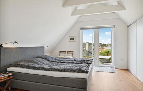 a bedroom with a bed and a large window at Lovely Home In Svendborg With Wifi in Svendborg