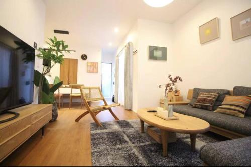 a living room with a couch and a table at Uhome Ikebukuro Villa 7 in Tokyo