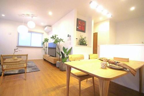 a living room with a table and a dining room at Uhome Ikebukuro Villa 7 in Tokyo