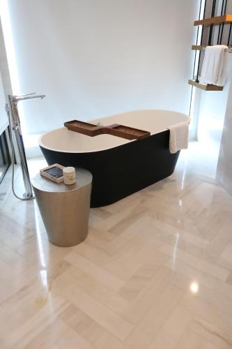 a bed in a room with a wooden floor at Renaissance Nanning Hotel in Nanning