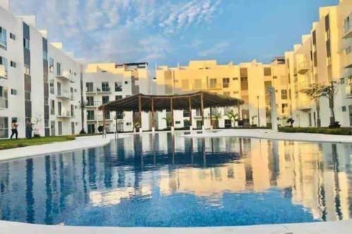 a large swimming pool in front of some buildings at Costa Malaga 1 Banus in Acapulco