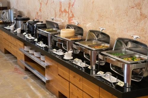 a buffet line with many plates of food at 沐棧行旅-花蓮Muchan Hotel-Hualien in Jian